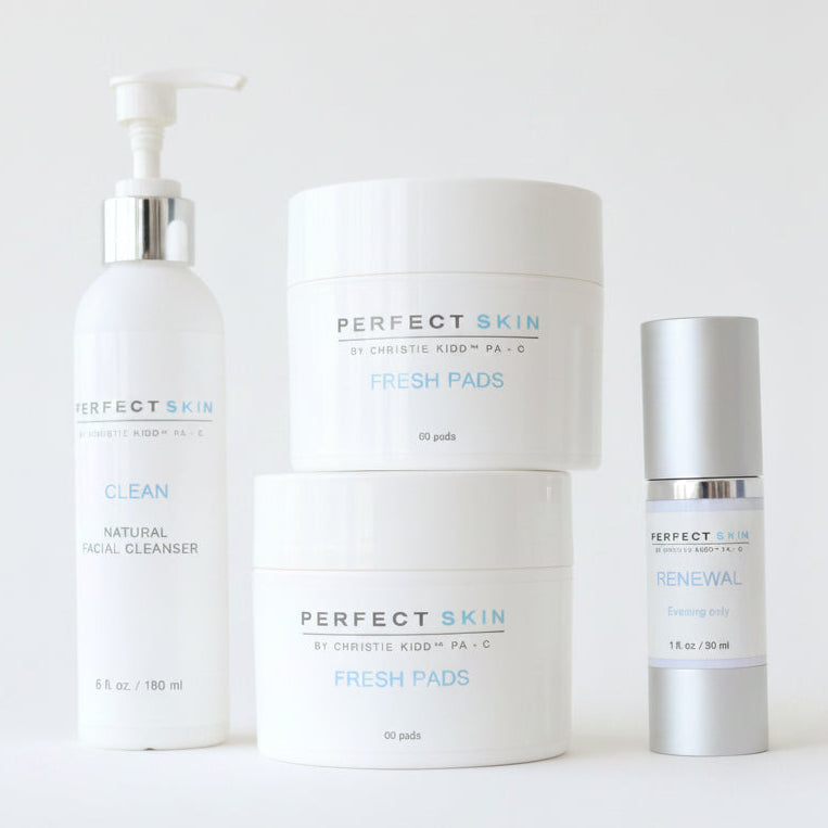 Skincare products on a stone surface with a neutral background